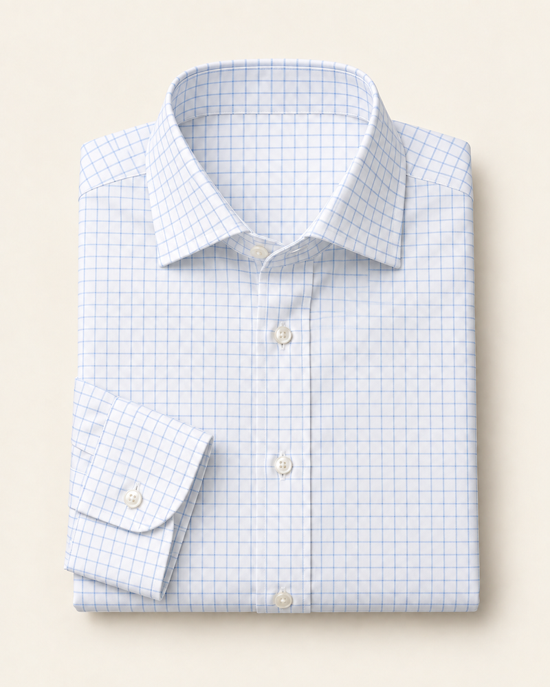 Illustrative white dress shirt with a fine blue check pattern, folded to show the collar and cuff.